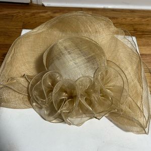 Soft sinamay straw derby hat with swirled self colored decorative .